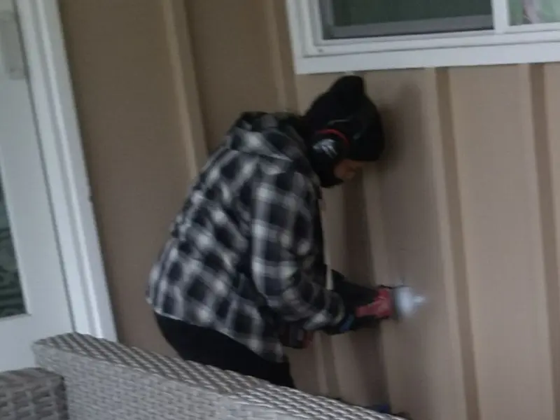 Professional electrician installing an exterior outlet in Perkins